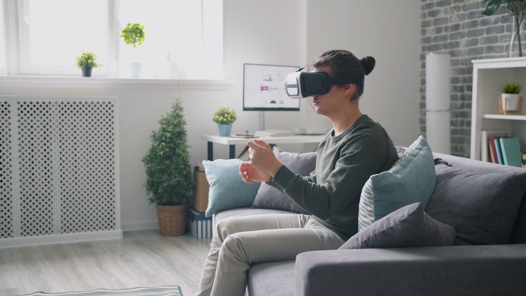 man wearing vr headset playing video game on couch virtual reality headset user immersive digital environment 3d avatar interaction