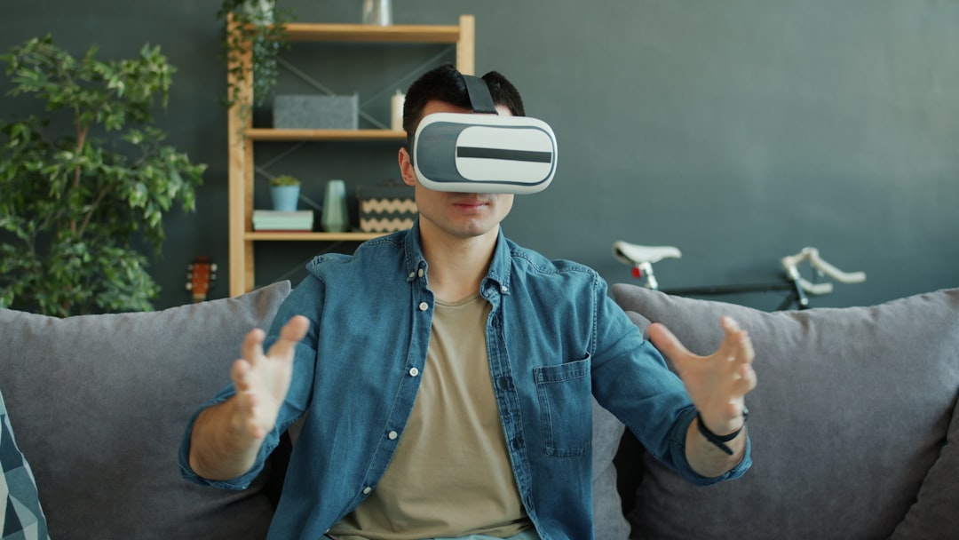 man wearing vr headset plays game on couch virtual reality headset user immersive digital environment 3d avatar interaction
