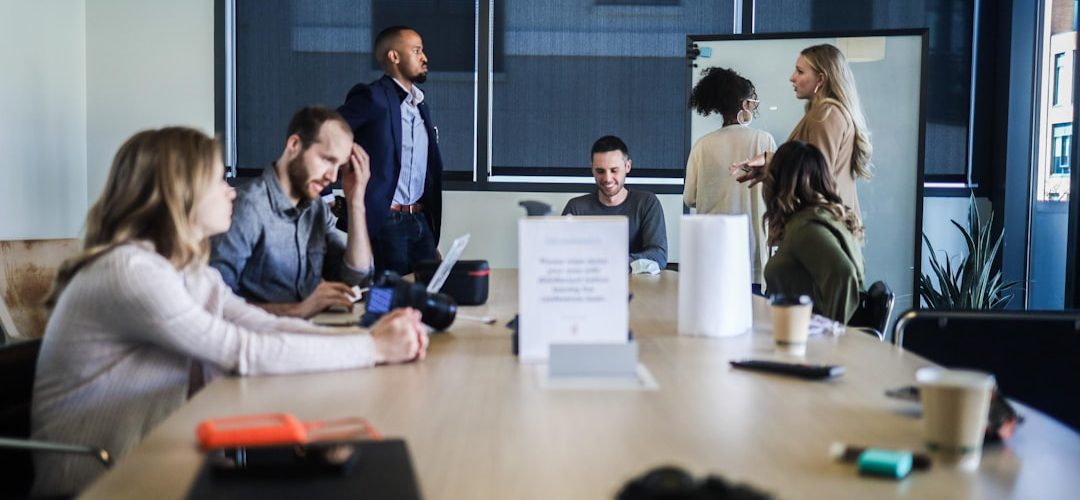 people sitting at the table office team retention strategy marketing meeting