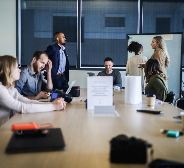 Sales Motivation Software: Platforms That Improve Team Performance 19 people sitting at the table office team retention strategy marketing meeting