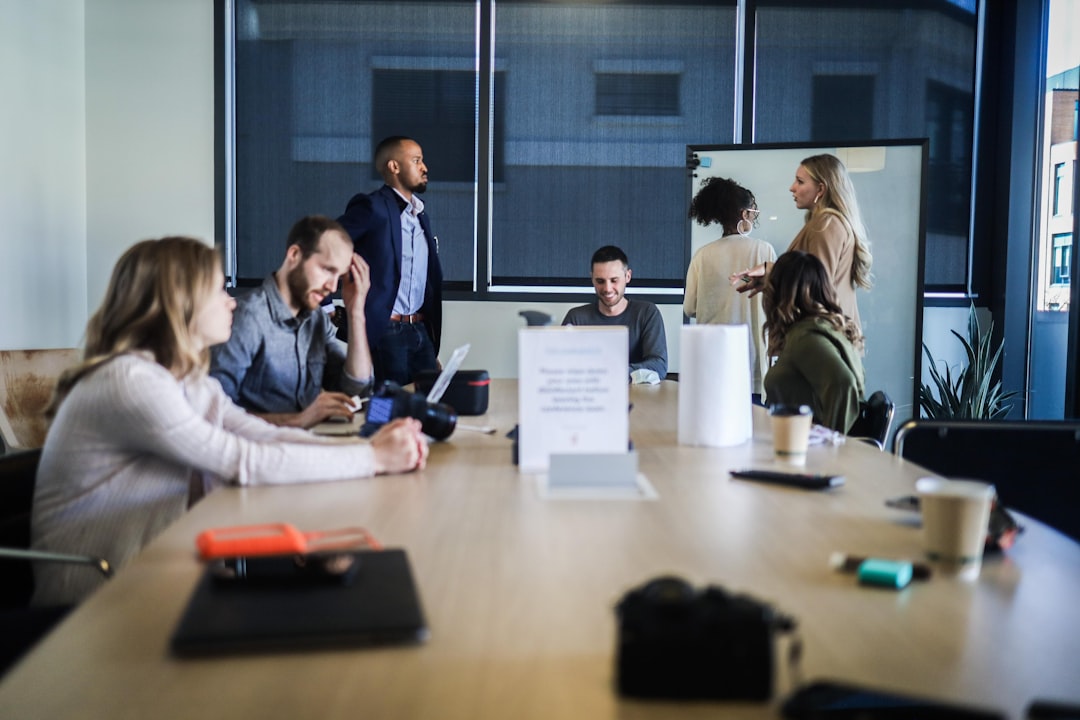 people sitting at the table office team retention strategy marketing meeting