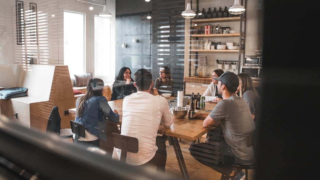 people sitting on chair office team retention strategy marketing meeting