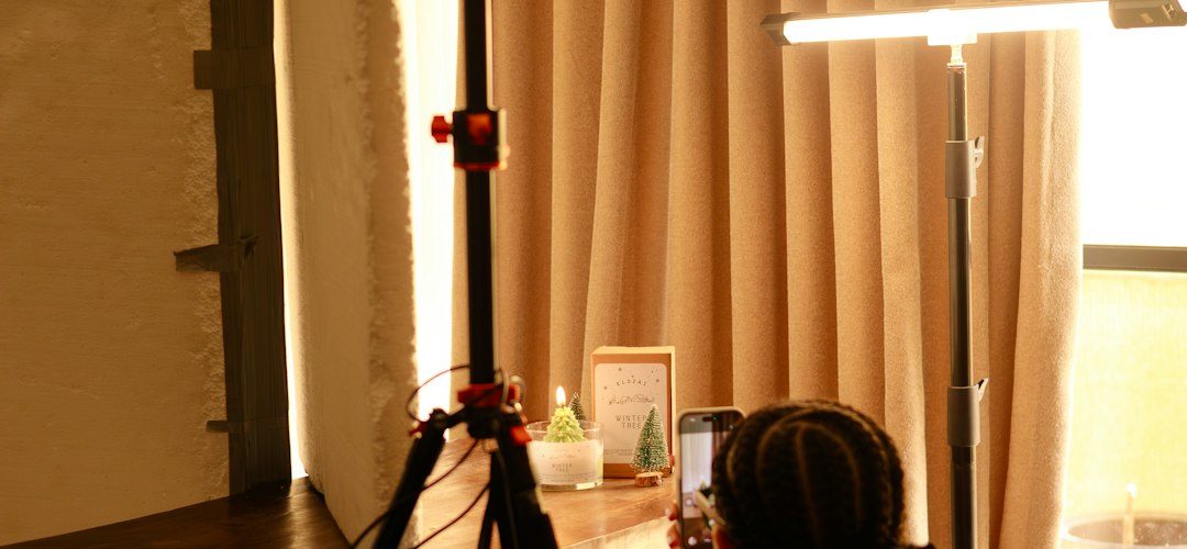 person filming with camera on tripod indoors camera setup film student soft light indoor studio