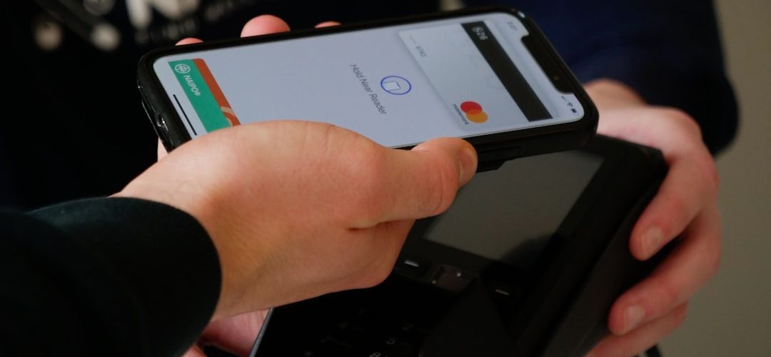 person holding black android smartphone mobile payment cash balance account closure