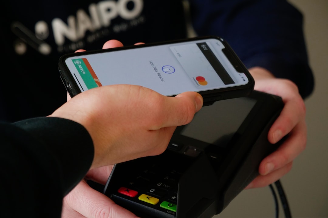 person holding black android smartphone mobile payment cash balance account closure