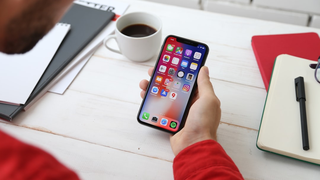 person holding space gray iphone x app launch iphone users digital product