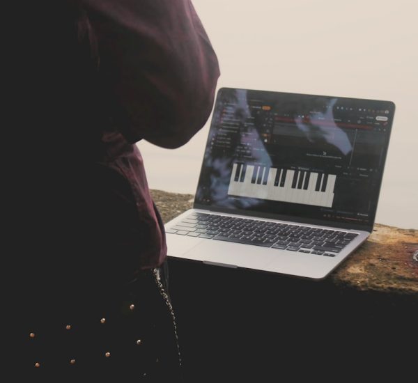 How Do You Troubleshoot “Unable to Expand Archive” Error 640 on macOS? 42 person using laptop with piano interface outdoors macbook startup screen waveform audio editing creative workspace