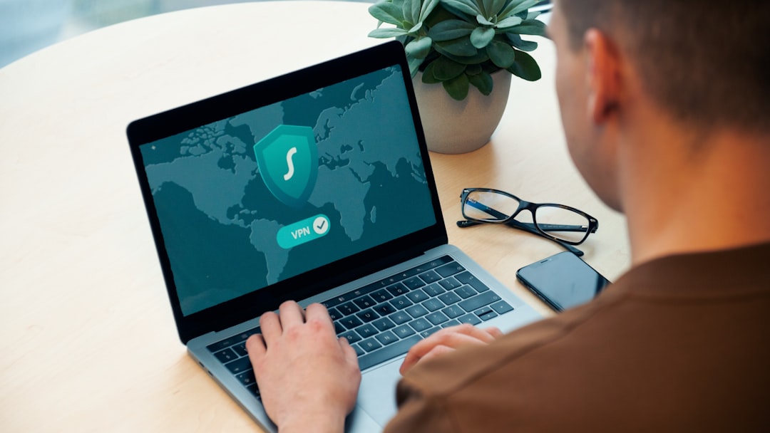 person using macbook pro on white table digital security biometric login identity verification