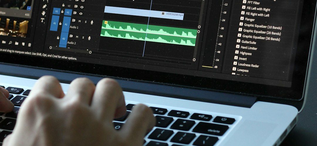 person using macbook pro turned on video editing timeline split clips fast workflow