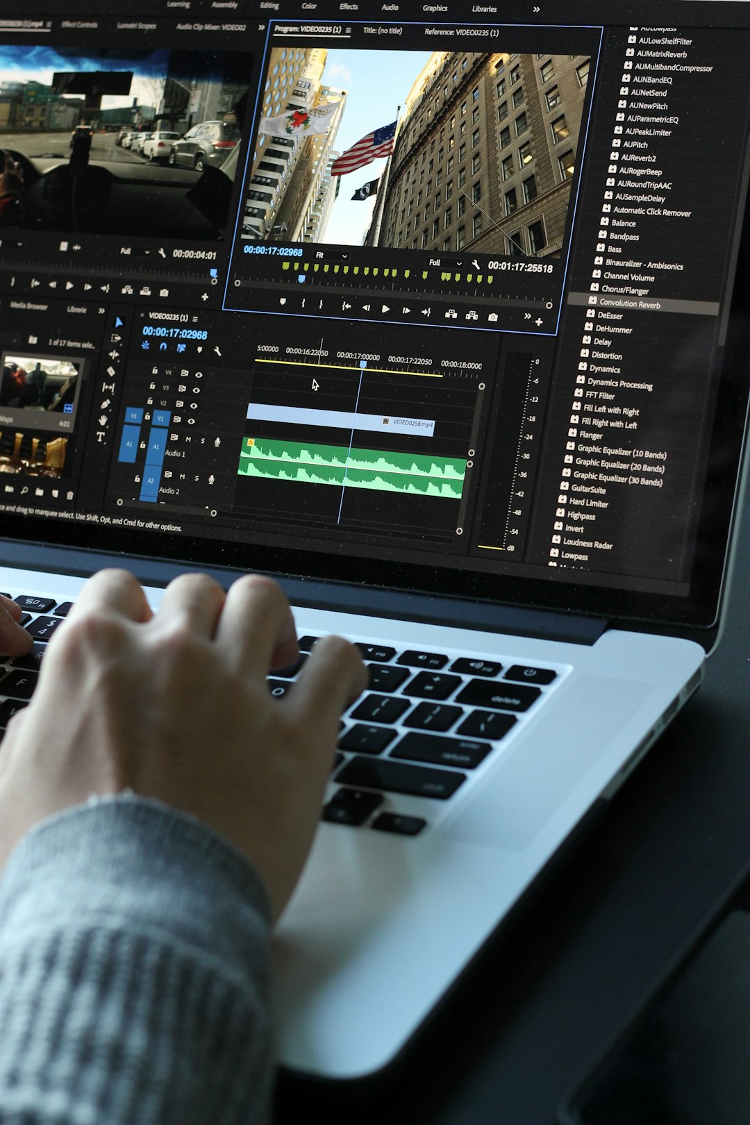 person using macbook pro turned on video editing timeline split clips fast workflow