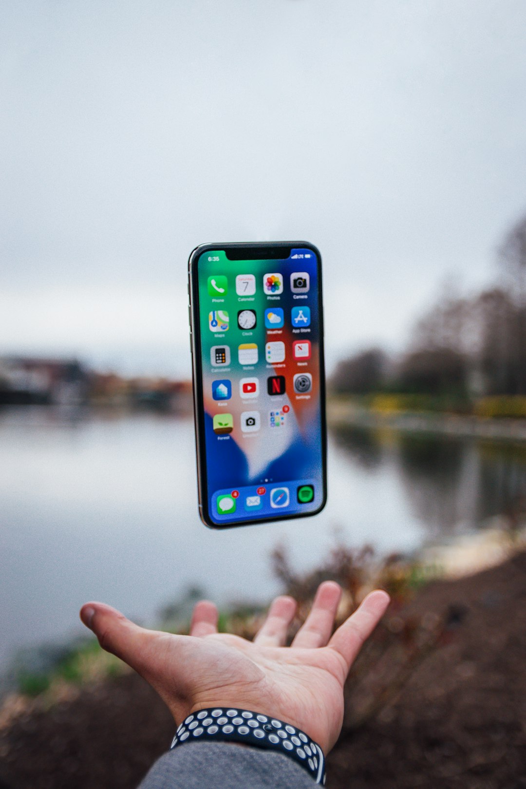 silver iphone x floating over open palm iphone app design development team mobile strategy 1