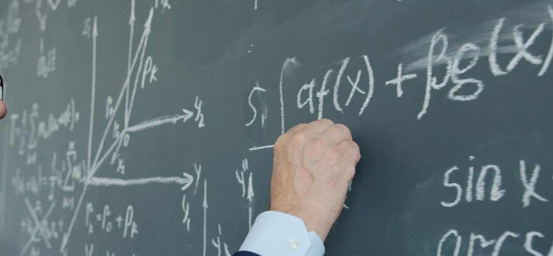 teacher writing mathematical formulas on a blackboard distributive property algebra steps teacher board