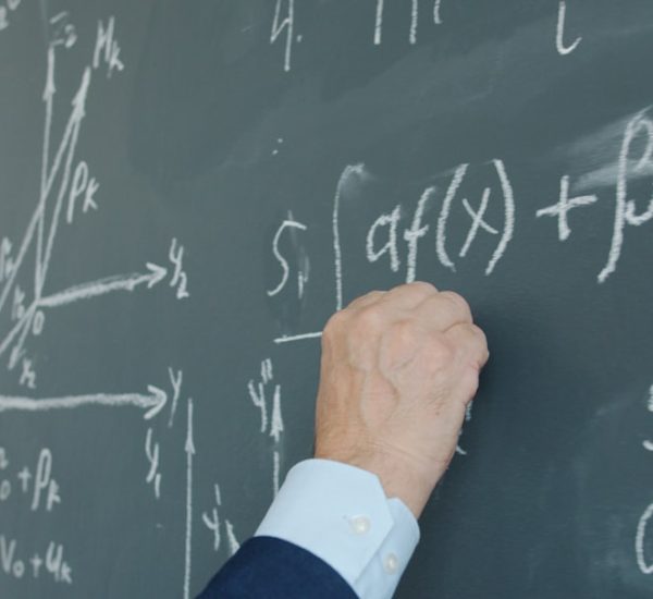 Fill-in-the-Blank Question Examples for Teachers and Online Quizzes 9 teacher writing mathematical formulas on a blackboard distributive property algebra steps teacher board