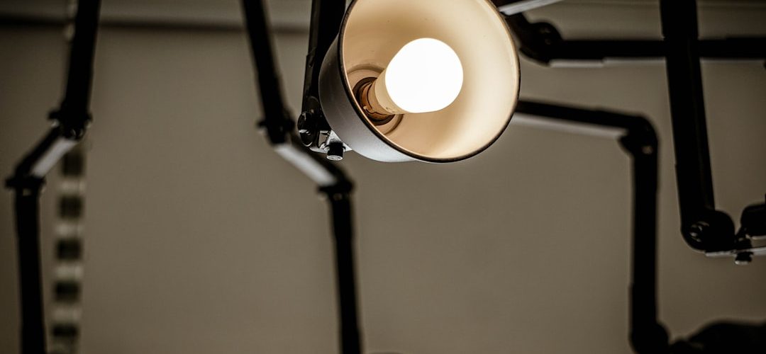 turned on white light with shade student robot tutor math worksheet glowing lightbulb