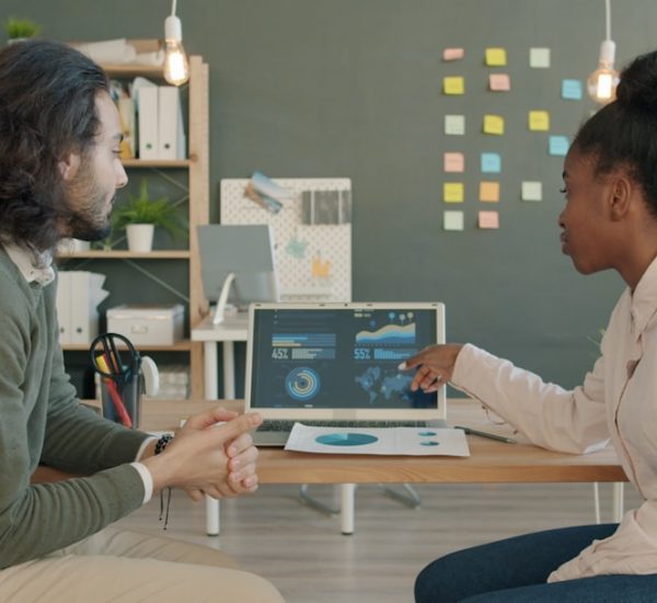 What Is Evergreen in Business? Definition & Examples 8 two colleagues discussing data on a laptop screen connected data digital transformation business growth analytics team 1