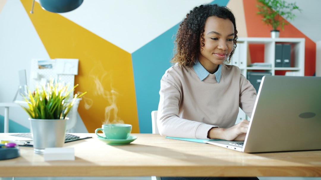 young woman typing on laptop with coffee nearby ai tools freelancer workspace online income