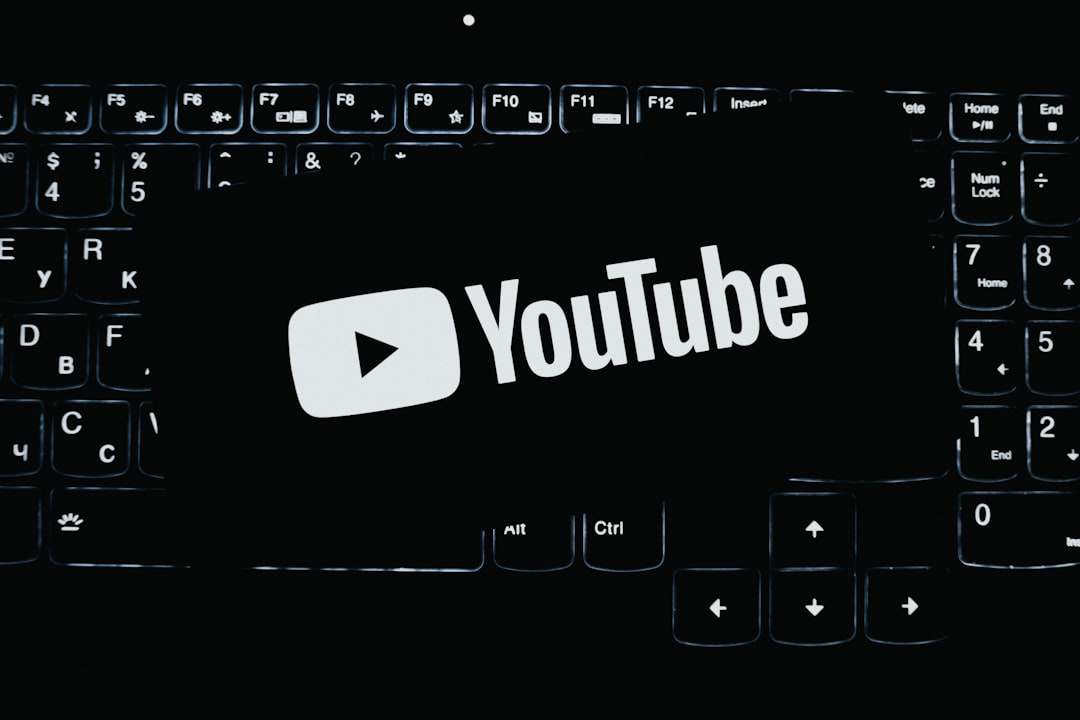 youtube logo on a dark illuminated keyboard download button saved video laptop browser