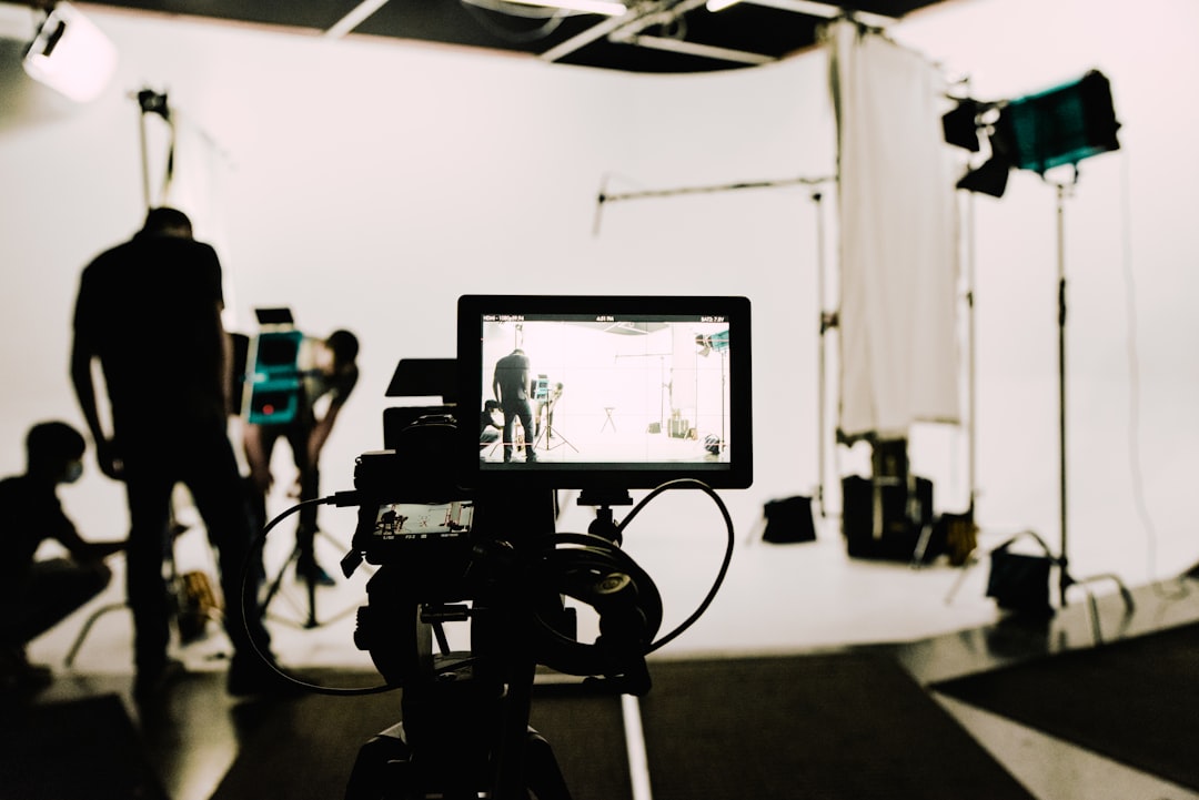 a camera set up in front of a white background behind the scenes shoot creative team studio setup