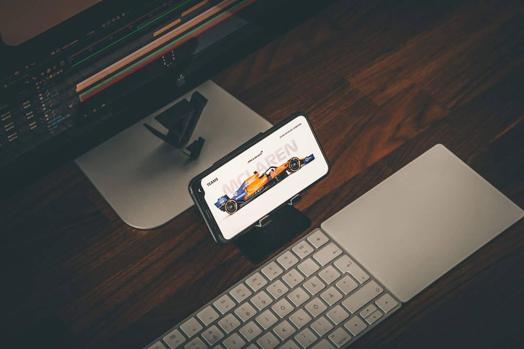 a cell phone sitting on top of a desk next to a keyboard animation workspace video editor creative dashboard