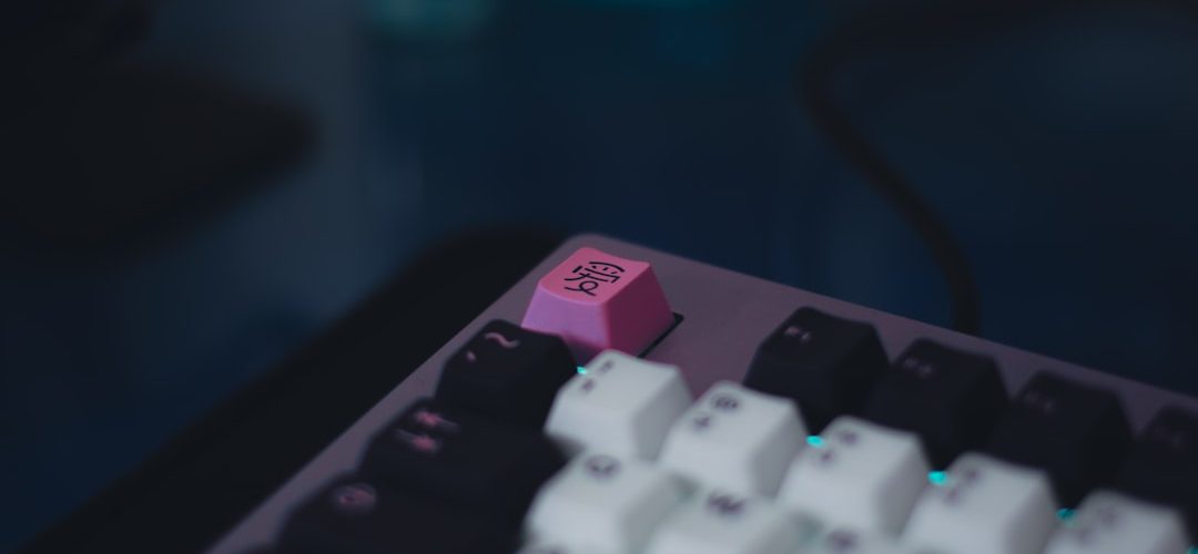 a close up of a pink and black keyboard gaming setup windows on mac controller