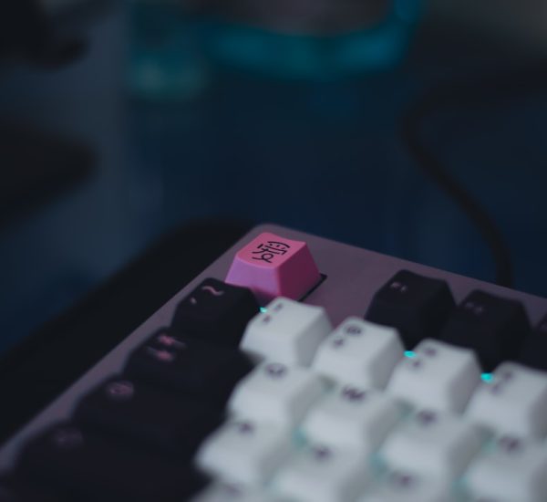 a close up of a pink and black keyboard gaming setup windows on mac controller
