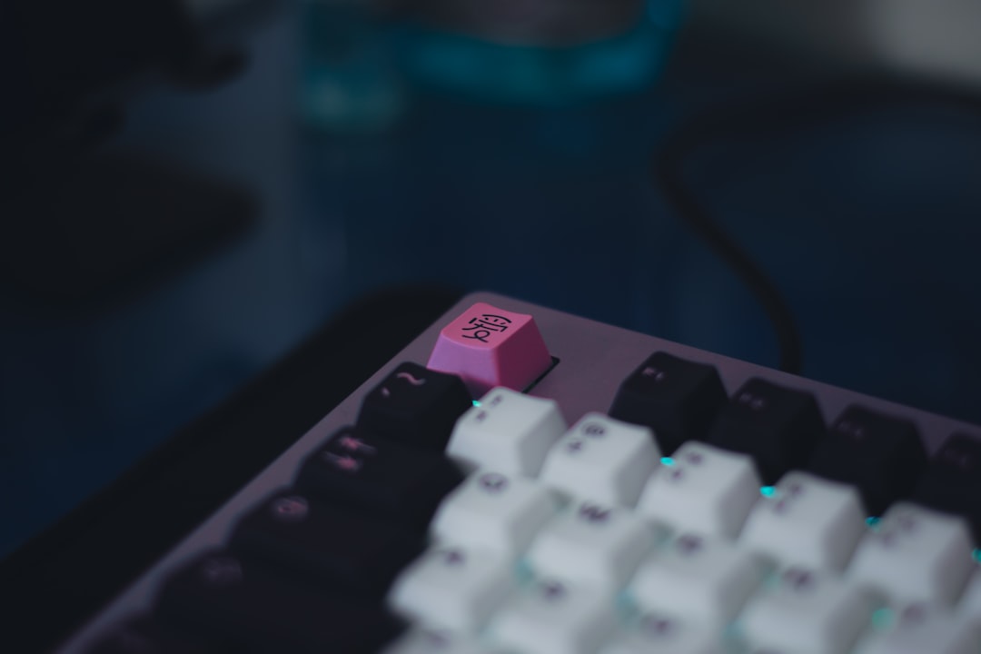 a close up of a pink and black keyboard gaming setup windows on mac controller