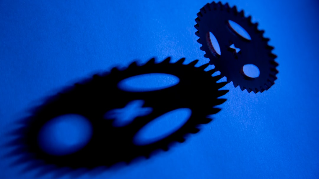 a couple of black gears sitting on top of a blue surface automation workflow linux terminal gears
