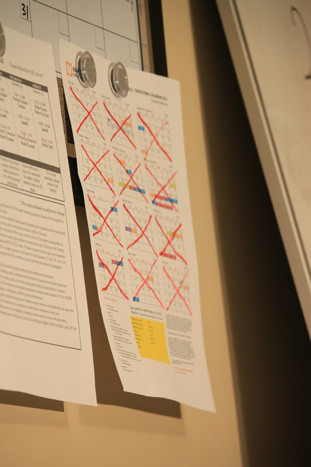 a couple of pieces of paper hanging on a wall incident action plan clipboard emergency map
