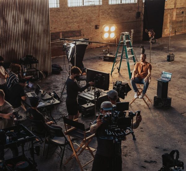 How Instagram Influencers Create and Manage Many Posts for Consistent Growth 8 a group of people standing around a camera set up behind the scenes shoot creative team studio setup