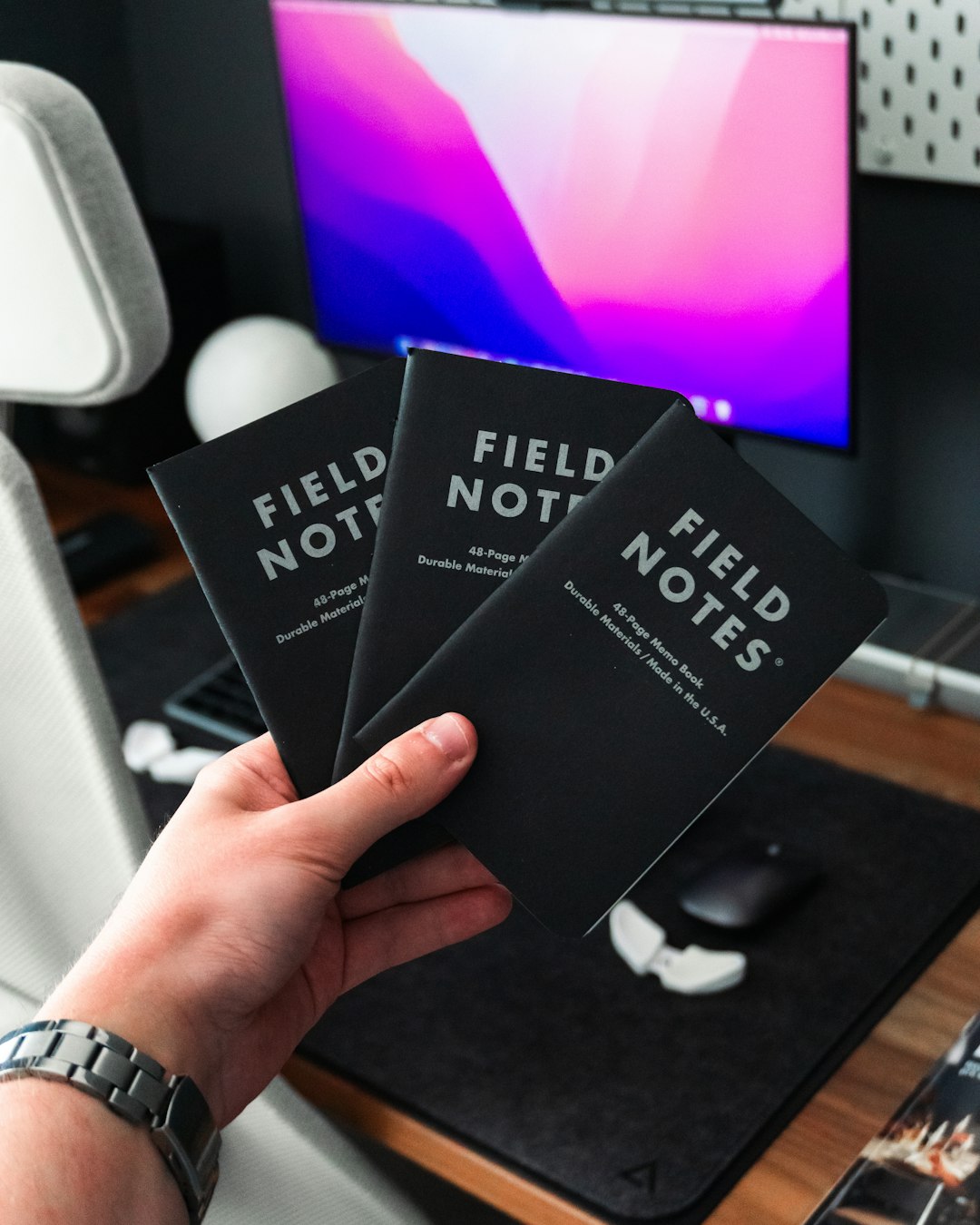 a hand holding a black box aviation charts study desk pilot books flashcards 1