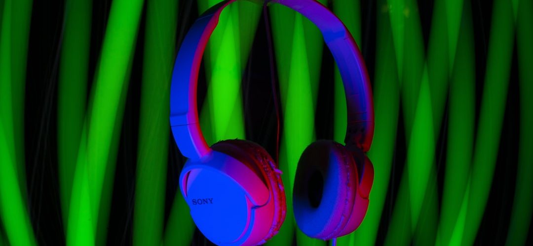 a pair of headphones sitting on top of a table playlist filters headphones colorful music