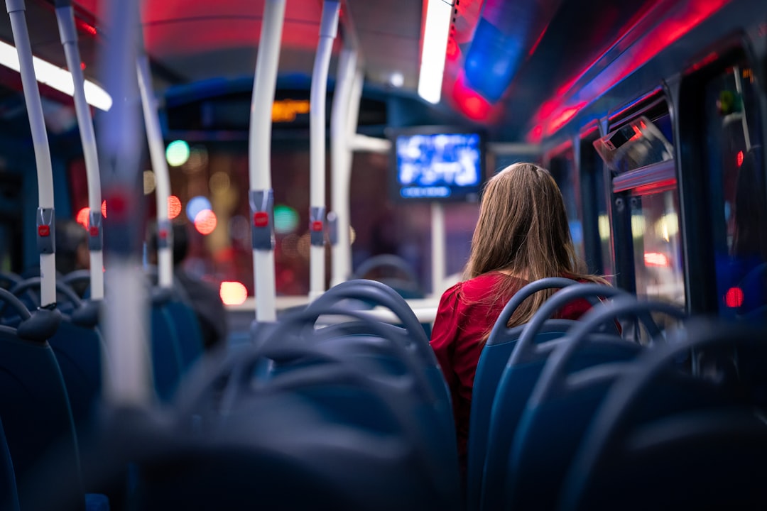 a person sitting on a bus bus interior passengers safety signs public transit