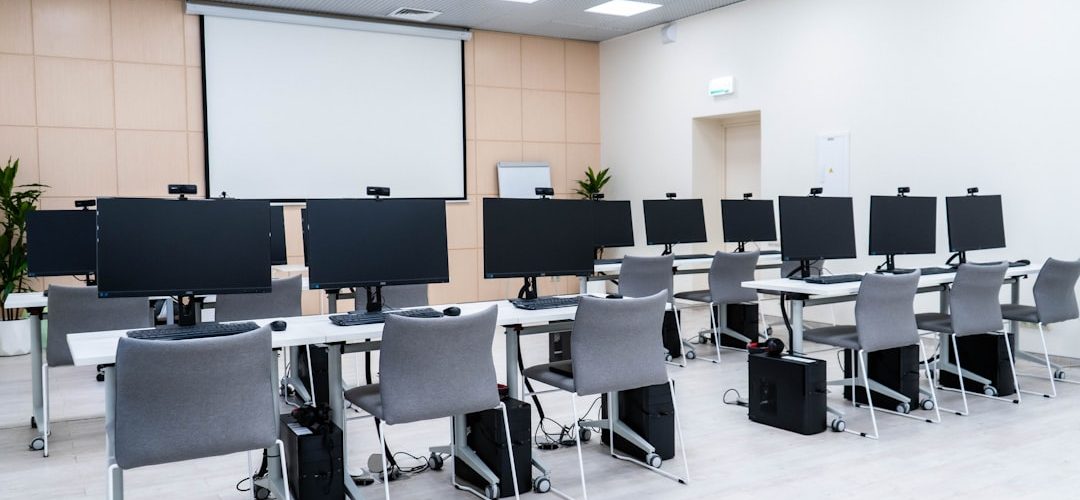 a room filled with lots of computer monitors university classroom digital calendar scheduling dashboard