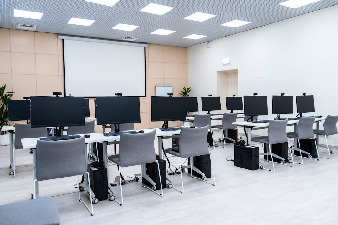 a room filled with lots of computer monitors university classroom digital calendar scheduling dashboard