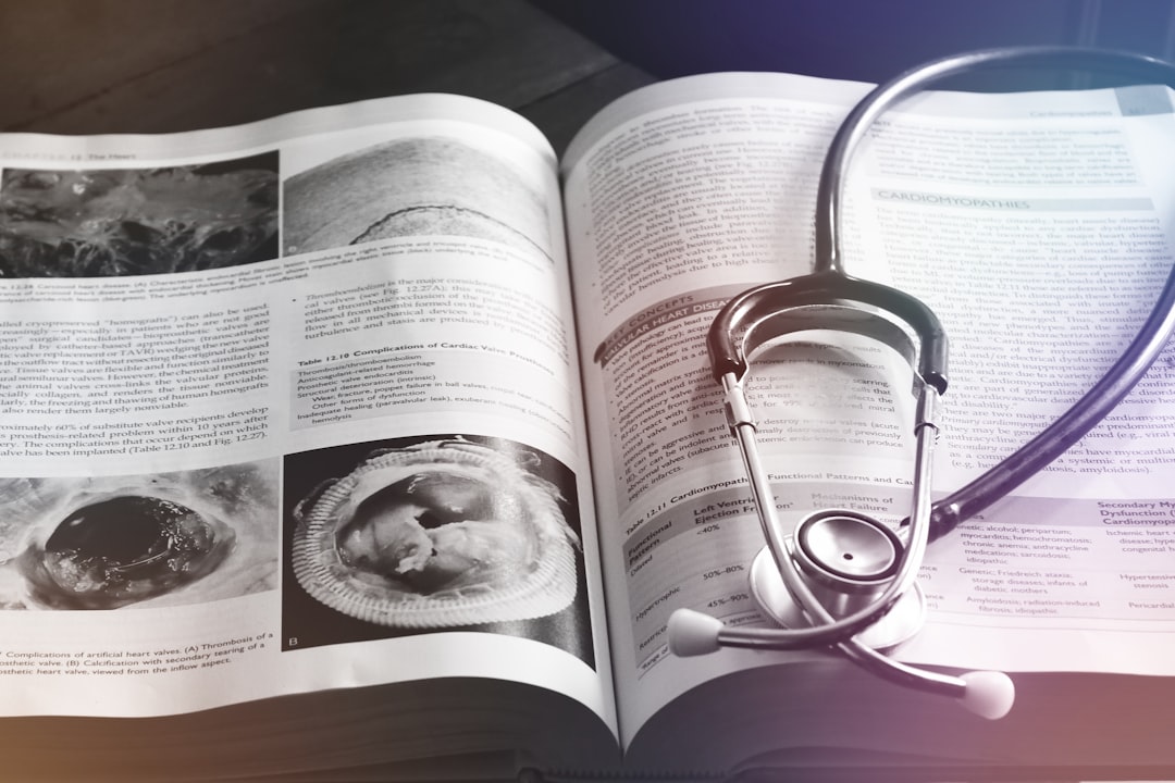 an open book with a stethoscope on top of it translator desk medical documents language books