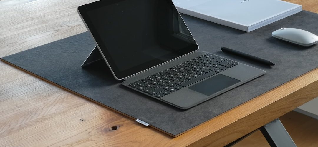 black and silver laptop computer on brown wooden table surface pen touchscreen drawing digital notes 1