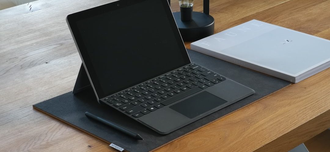 black and silver laptop computer on brown wooden table surface pen touchscreen drawing digital notes 3