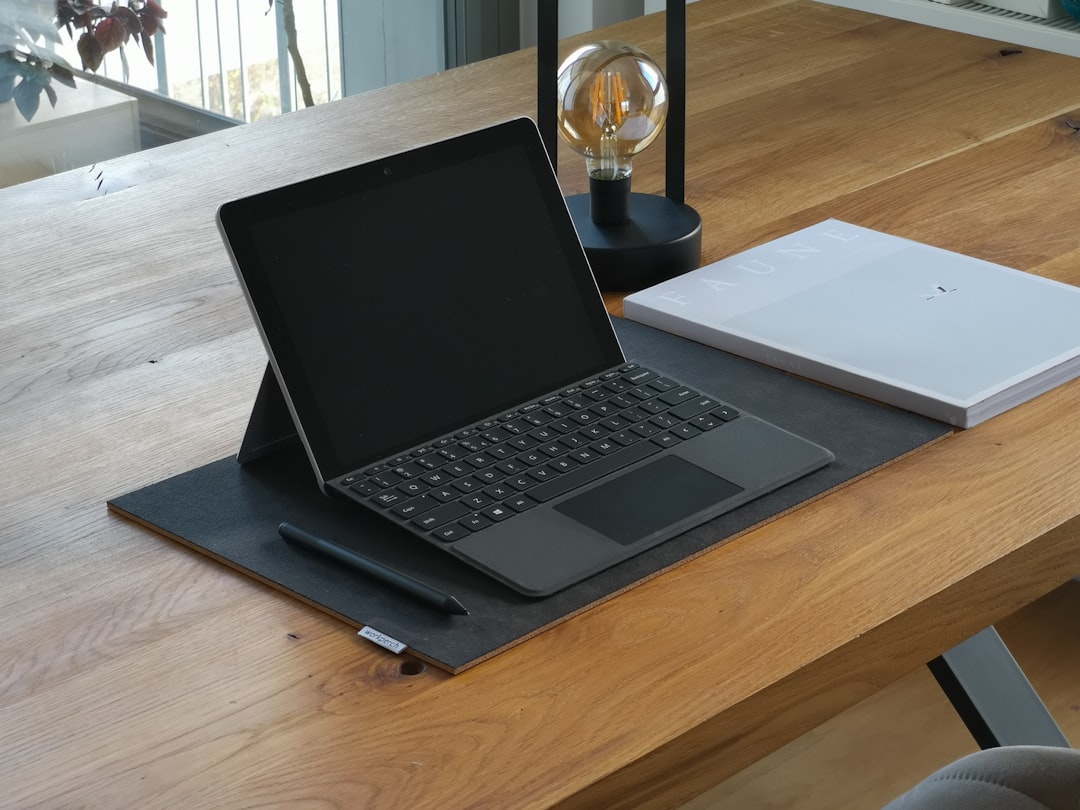 black and silver laptop computer on brown wooden table surface pen touchscreen drawing digital notes 3
