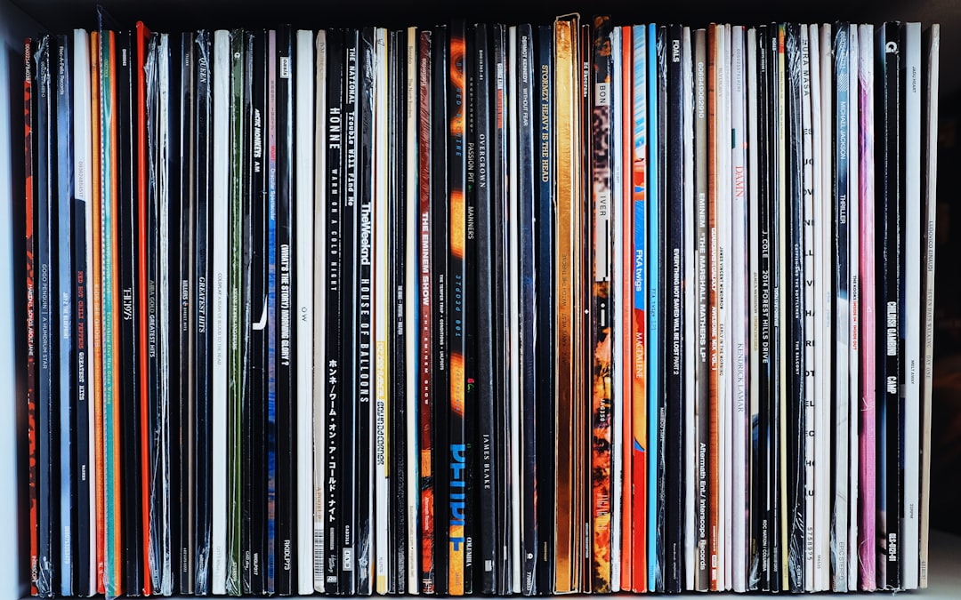 black wooden shelf with books music timeline vinyl records glowing years