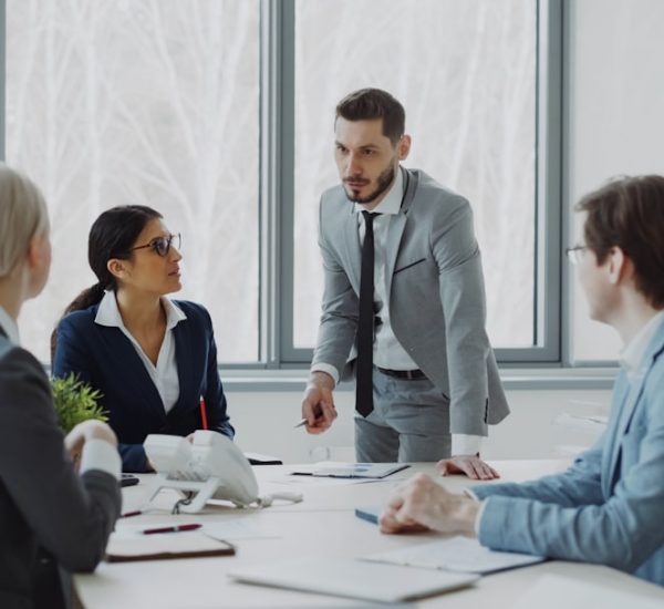 How to Identify Sponsorship Decision Makers 22 business professionals in a meeting around a table business meeting strategy board team alignment objectives