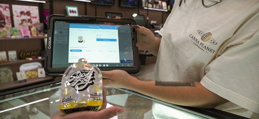 customer holds product at counter with cashier using tablet mobile shop point of sale smartphones retail counter 1