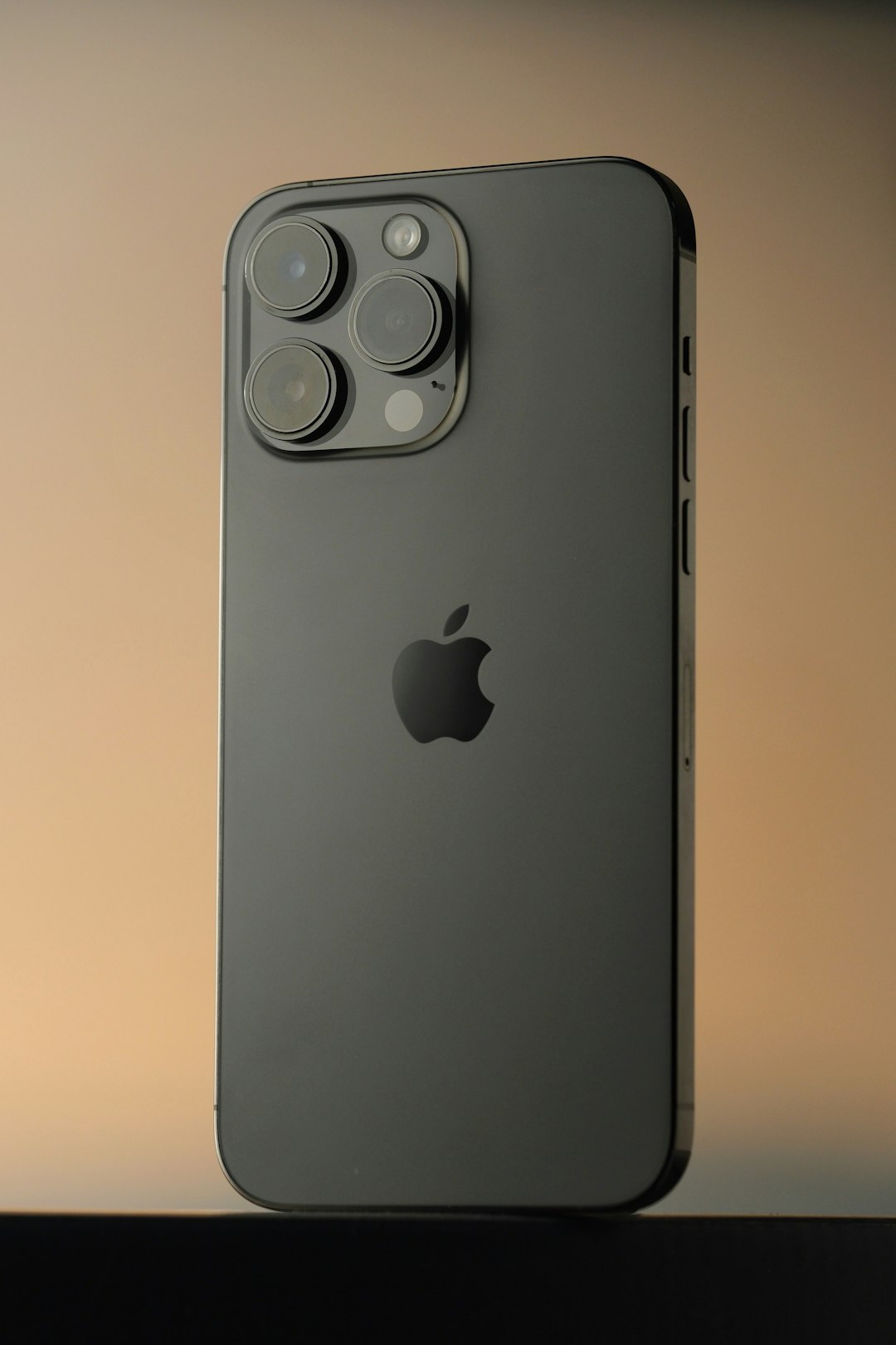 dark gray iphone 14 pro with camera array apple flagship phones blue pro max smartphone lineup studio lighting