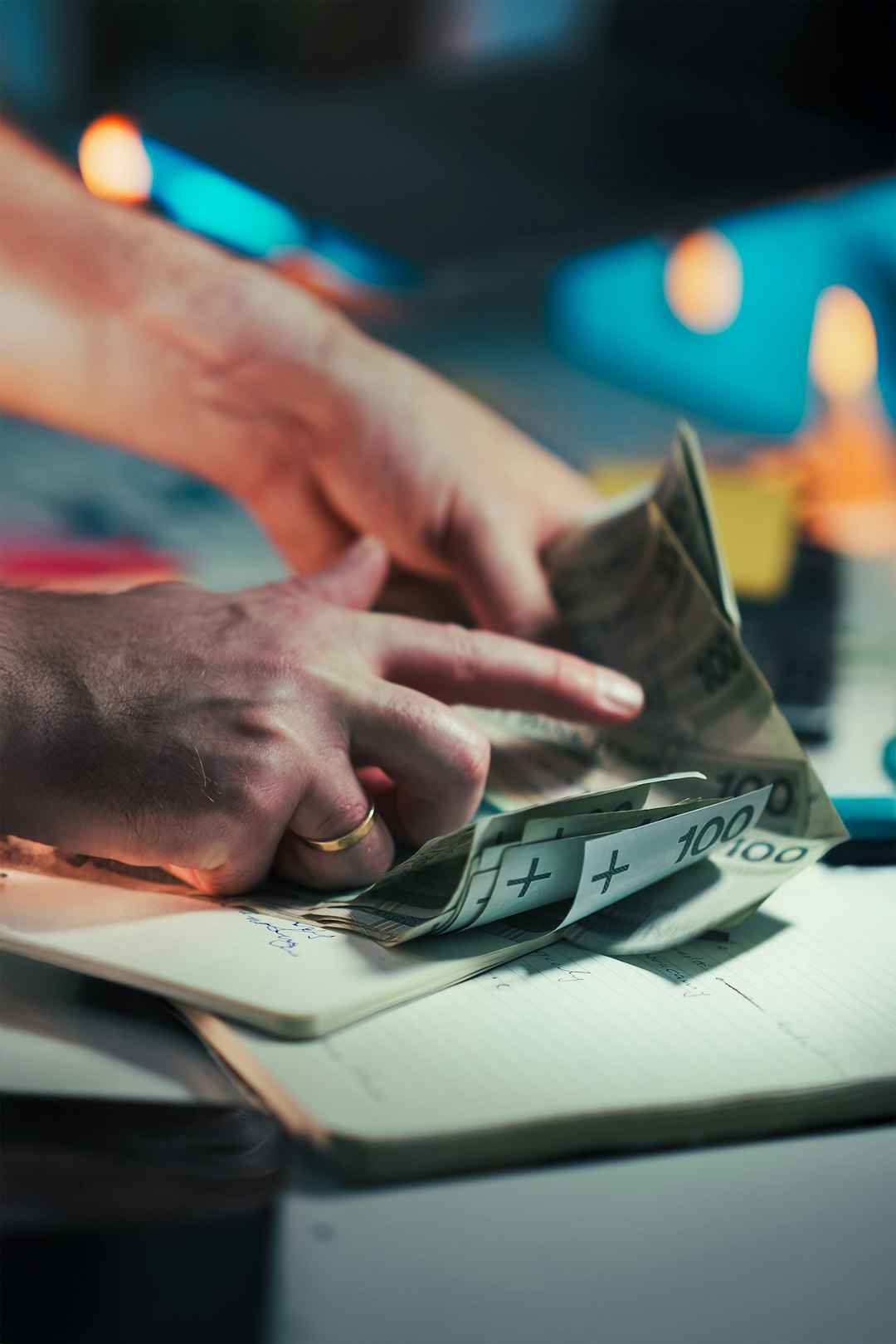 hands counting polish banknotes on a notebook budget planning subscription pricing team savings