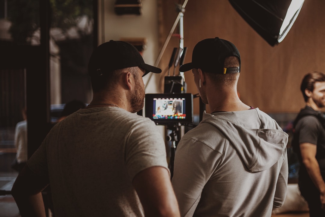 man in white crew neck t shirt wearing black sunglasses team collaboration video production online workflow