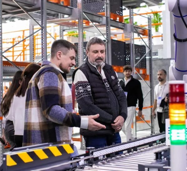 Rhino 3D vs AutoCAD vs SolidWorks vs Fusion 360 10 men observe automated conveyor belt system in warehouse industrial 3d printing engineered parts manufacturing facility