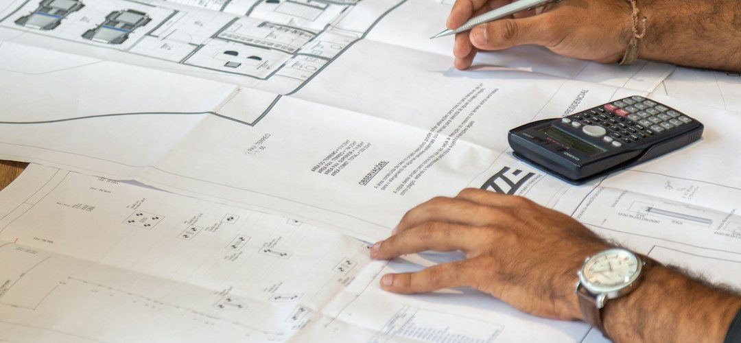 people reviewing architectural blueprints on desk professional services team project planning client reports