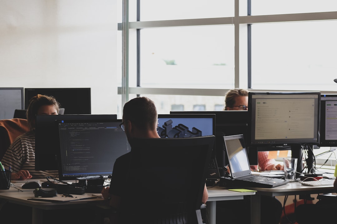 people sitting on chair in front of computer monitor business software dashboard client management team workflow