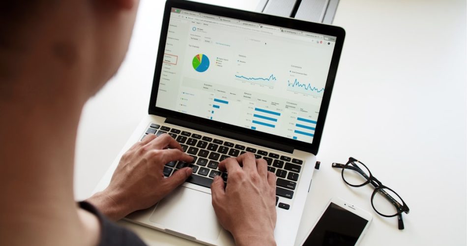 person using macbook pro technician reviewing email reports security charts client domains
