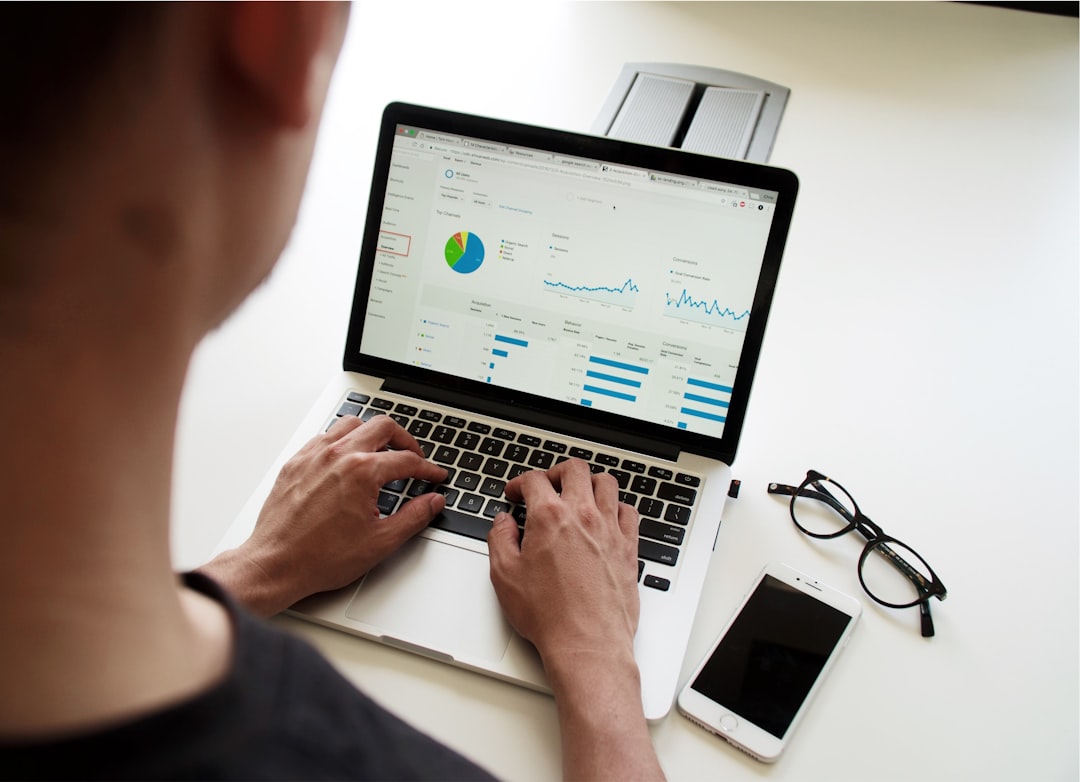 person using macbook pro technician reviewing email reports security charts client domains