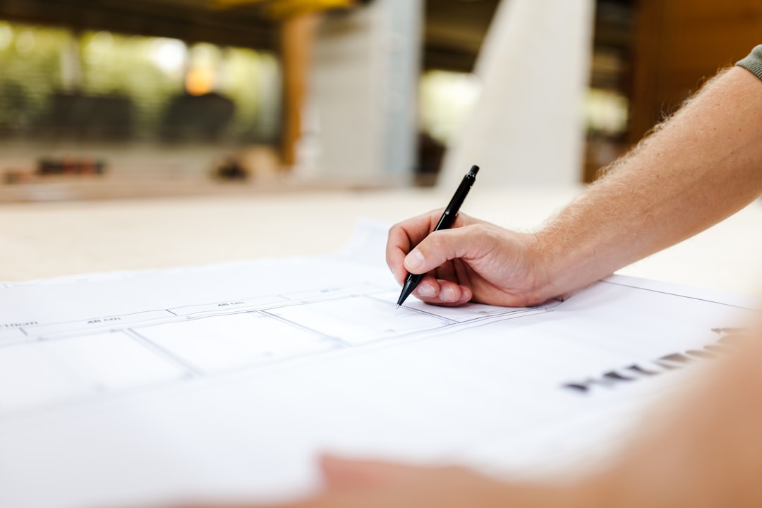person writing on white paper professional services team project planning client reports
